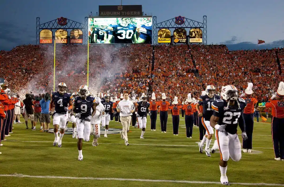 Auburn football players run onto the field at a packed Jordan-Hare Stadium in Auburn, Alabama.