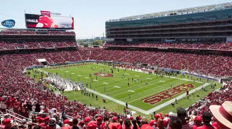 A packed Levi's Stadium crowd watches the 49ers on a sunny day in Santa Clara, California.