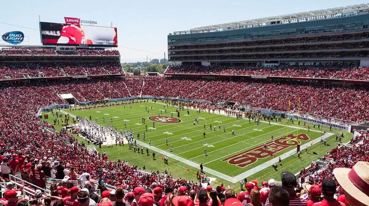 A packed Levi's Stadium crowd watches the 49ers on a sunny day in Santa Clara, California.
